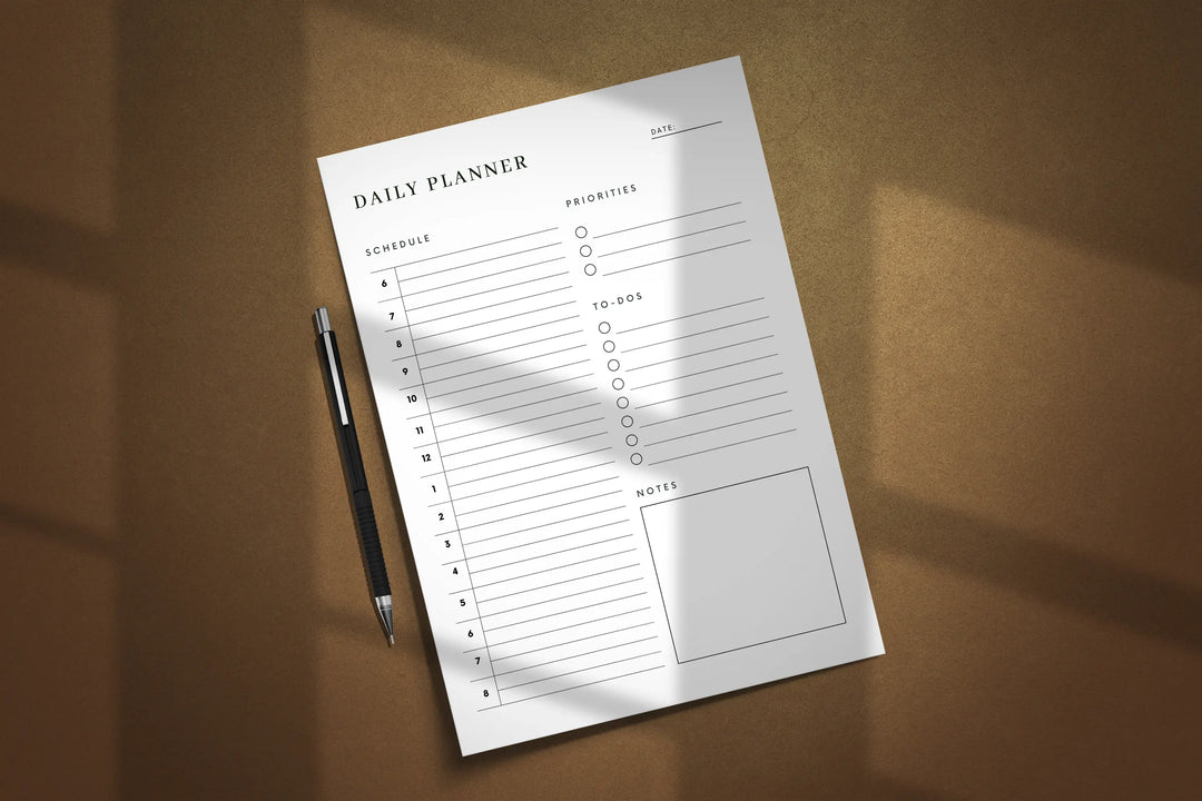 Daily planner sheet with a pen on a brown surface