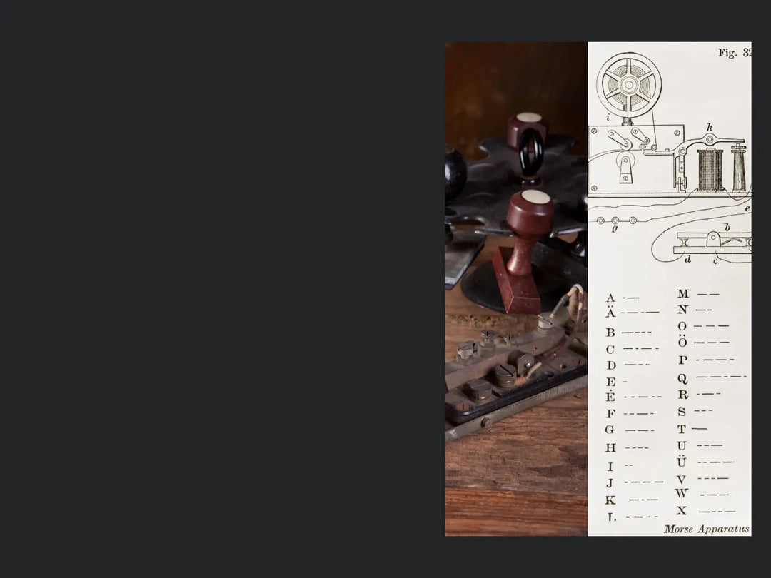 A vintage Morse Code apparatus setup shown alongside a printed diagram and alphabet key page, with a dark gray background and a wooden tabletop visible.