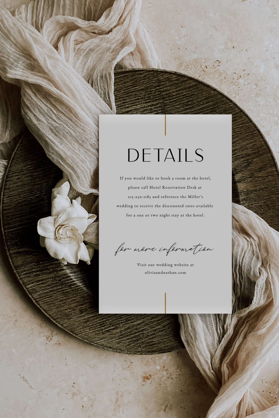 Wedding details card on a wooden plate with flowers and fabric