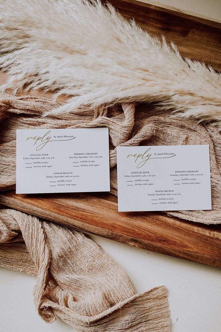 Two wedding invitation rsvp  cards on a textured fabric surface