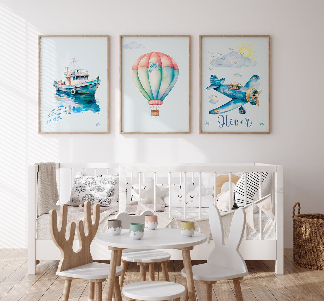 Children's room with a crib, table, chairs, and wall art depicting a boat, hot air balloon, and airplane.