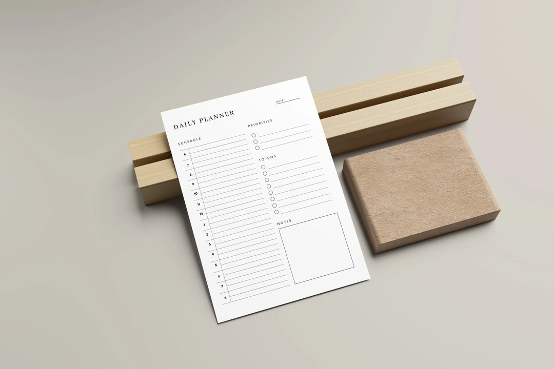 Daily planner sheet with wooden blocks on a light gray background